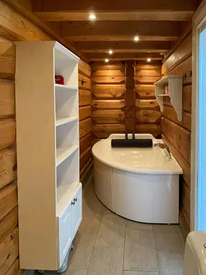 a bathroom with a white tub and wooden walls at Log Cabin With A View At Golsfjellet in Gol