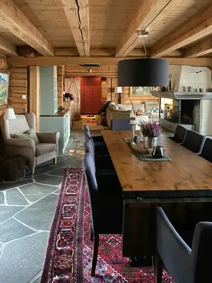 a living room with a large wooden table and chairs at Log Cabin With A View At Golsfjellet in Gol