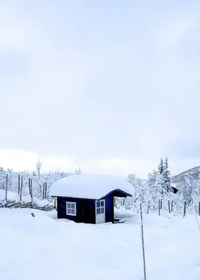 a small shed covered in snow in a field at Cottage Near Grønnsenknipa With Skiing And Hiking in Ron