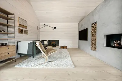 a living room with a chair and a fireplace at Stylish Cabin Near Oppdal Ski Centre in Oppdal