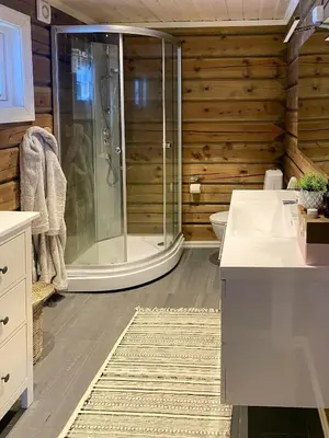 a bathroom with a shower and a sink at Timber Cabin With Outdoor Spa Near Stranda in Brunstad