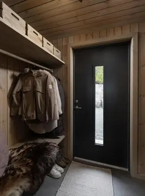 a black door in a small room with a coat at New Cabin At Norefjell With Mountain Panorama in Noresund