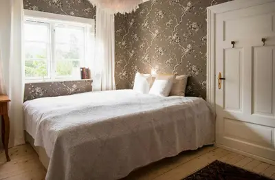 a bedroom with a bed and a window at Antique House With Lake View Near Lillehammer in Fryjordet