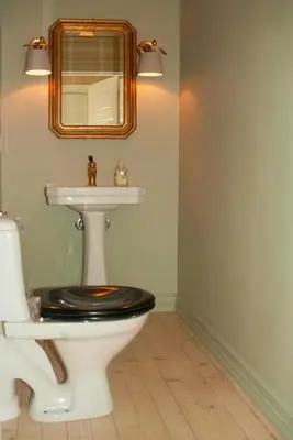 a bathroom with a toilet and a sink at Antique House With Lake View Near Lillehammer in Fryjordet