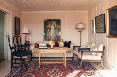 a living room with a table and a couch at Antique House With Lake View Near Lillehammer in Fryjordet