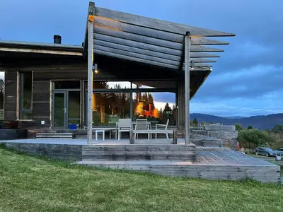 a house with a porch with chairs on it at Villa Vetleskog On Mollandsmarki In Sogn in Hafslo