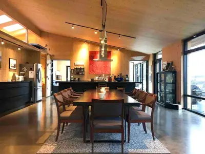 a dining room with a wooden table and chairs at Villa Vetleskog On Mollandsmarki In Sogn in Hafslo