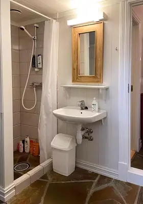 a bathroom with a sink and a shower curtain at Log Cabin With Panoramic Views At Skeikampen in Svingvoll