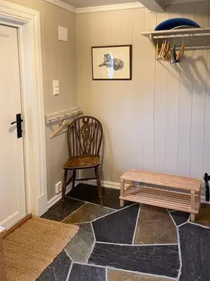 a room with a wooden chair and a bench at Log Cabin With Panoramic Views At Skeikampen in Svingvoll