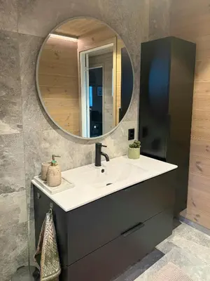 a bathroom with a sink and a mirror at Modern Cabin For Large Families In Oppdal in Oppdal