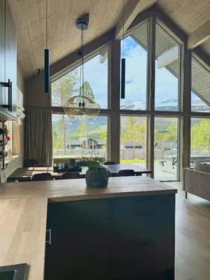 a large room with a kitchen with large windows at Modern Cabin For Large Families In Oppdal in Oppdal