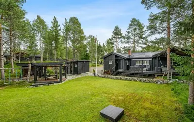 a house in the woods with a yard at Family-Friendly Cabin With Zipline Near Oppdal in Rennebu