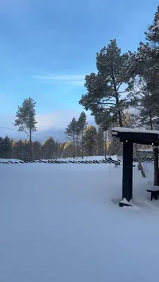 a bench sitting in the snow in a park at Family-Friendly Cabin With Zipline Near Oppdal in Rennebu