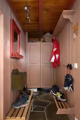 a room with a bunch of shoes in a cabin at 6 Bed traditional mountain cabin in Geilo - close to skiing and hiking in Hol