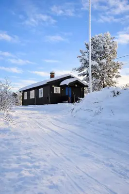 a house with snow on the ground in front at 6 Bed traditional mountain cabin in Geilo - close to skiing and hiking in Hol
