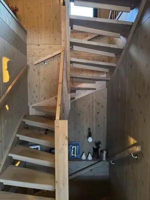 a wooden staircase in a room with wooden walls at Beautiful Ski-in Ski-out Cabin at the top of the mountain in Hafjell in Hafjell