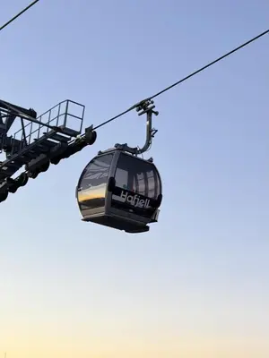 a gondola lift in a blue sky at Beautiful Ski-in Ski-out Cabin at the top of the mountain in Hafjell in Hafjell