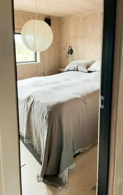 a bedroom with a bed and a large window at Cabin At Groholsfjellet For Active Days in Veggli