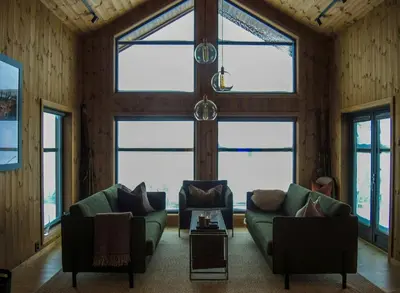 a living room with two couches and windows at Cabin With Sauna And Views Over Hallingdal in Flå