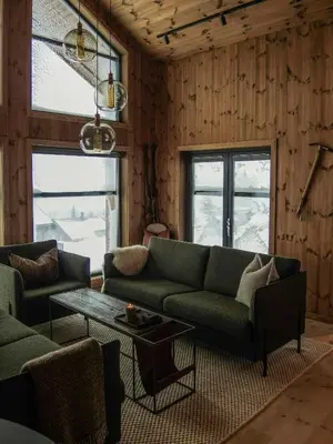 a living room with a green couch and a table at Cabin With Sauna And Views Over Hallingdal in Flå