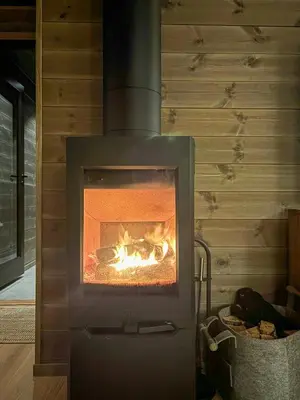 a stove with a fire in a room at Cabin With Ski-Inski-Out At Stranda Ski Resort in Stranda