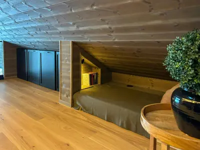 a bed in a room with a wooden ceiling at Cabin With Ski-Inski-Out At Stranda Ski Resort in Stranda