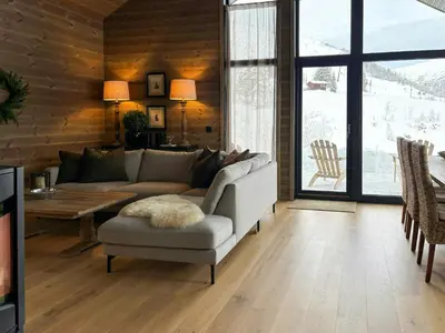 a living room with a couch and a table at Cabin With Ski-Inski-Out At Stranda Ski Resort in Stranda