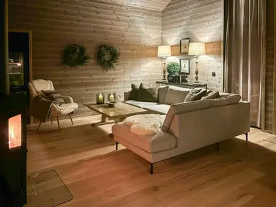 a living room with a couch and a table at Cabin With Ski-Inski-Out At Stranda Ski Resort in Stranda