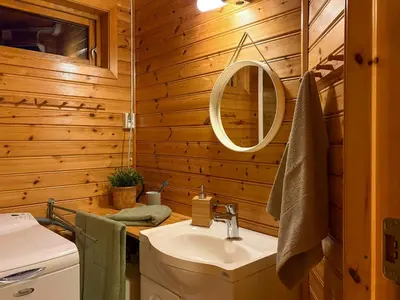 a bathroom with a sink and a mirror at Cabin On Hilltop With Beach And Sea Views in Bekkjarvik