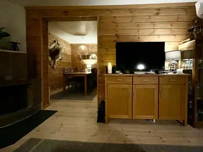 a room with a kitchen with a tv and a table at Renovated Cabin On The West Side Of Trysil in Trysil
