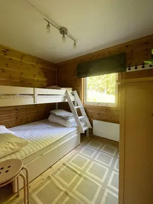 a bedroom with two bunk beds and a window at Renovated Cabin On The West Side Of Trysil in Trysil