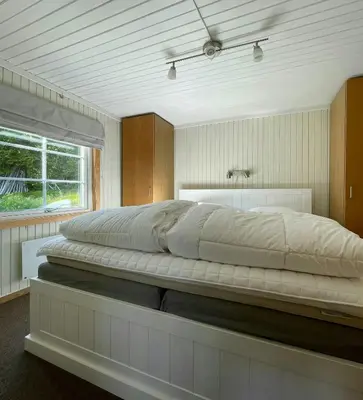 a large bed in a bedroom with a window at Renovated Cabin On The West Side Of Trysil in Trysil