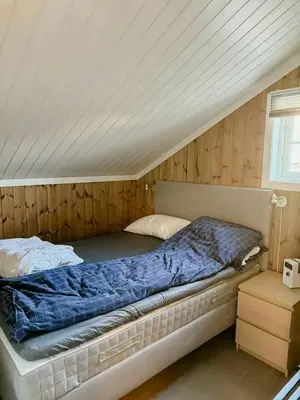 a bed in a room with a wooden ceiling at Cabin Near Ski Trails In Tempelseter in Eggedal