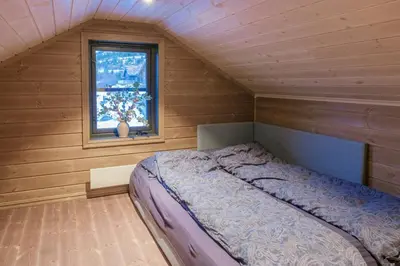a bedroom with a bed in a room with a window at Modern Cabin With Ski-Inski-Out At Hafjell in Øyer