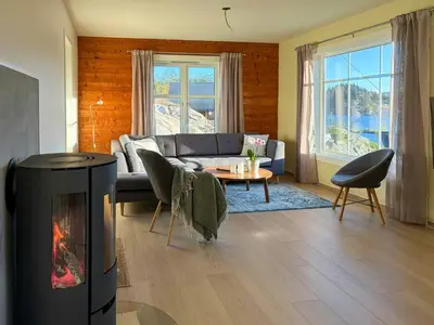 a living room with a couch and a fireplace at Seafront House From 1952 With Views In Veivåg in Bekkjarvik