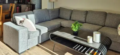 a living room with a couch and a table at Flat With Lake View In Sjusjøen in Sjusjøen