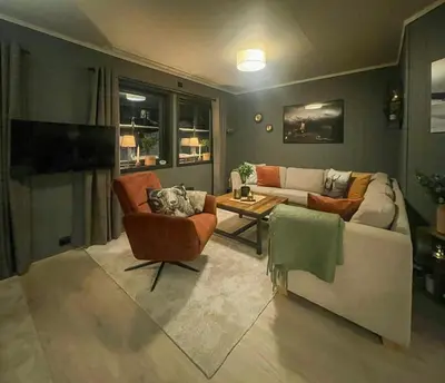 a living room with a couch and chairs and a table at Apartment With Ski Inout In Fageråsen Trysil in Trysil
