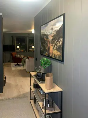 a living room with a painting of a deer on the wall at Apartment With Ski Inout In Fageråsen Trysil in Trysil