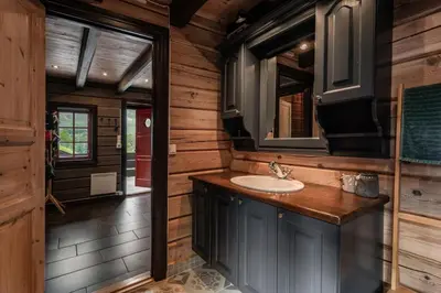 a bathroom with a sink and a mirror at Charming cabin by Hallingskarvet ski center in Hol