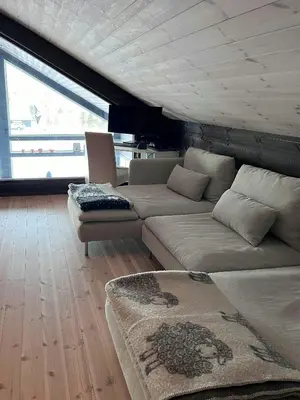 a living room with a couch and a table at Moderne Og Koselig Hytte På Hardangervidda in Garden