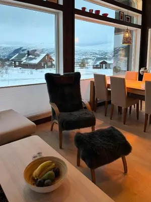 a living room with a table with a bowl of fruit at Moderne Og Koselig Hytte På Hardangervidda in Garden