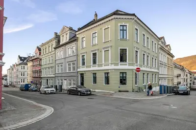 a group of buildings on a street with cars parked at Central stay apartment - Rosenberg in Bergen