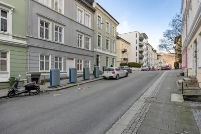 a street with cars parked on the side of the road at Central stay apartment - Rosenberg in Bergen