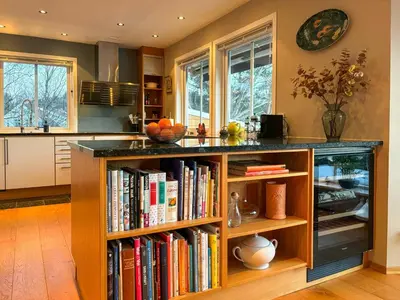 a kitchen with a book shelf filled with books at House With 90 Metres Private Beach On Bømlo in Ervik