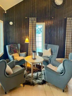 a living room with blue chairs and a table at Family Cabin With Hot Tub At Skeikampen in Svingvoll