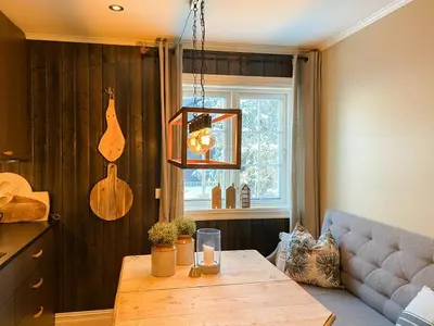 a living room with a table and a couch at Family Cabin With Hot Tub At Skeikampen in Svingvoll