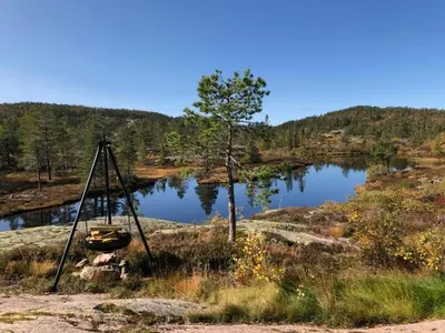 a boat on a tripod next to a lake at Fjellhytte med boblebad og utsikt på Blefjell in Flesberg