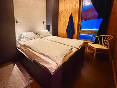 a small bed in a room with a window at Elegant 2 bedroom ski in, ski out apartment next to Fyri Resort in Hemsedal in Hemsedal