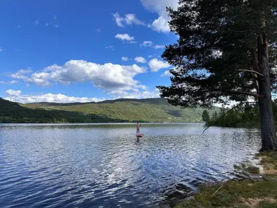a person is standing in the middle of a lake at Winter paradise Norefjell in Surteberg