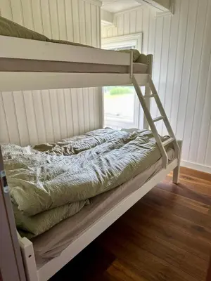 a bunk bed in a room next to a window at Winter paradise Norefjell in Surteberg